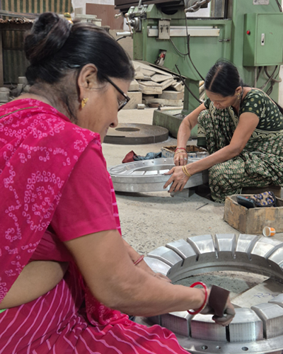Quality control technician inspecting a die or mold using advanced measuring equipment.